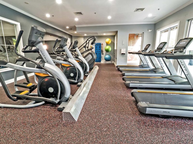 This image showcases commercial fitness with a State-of-the-art 2-level athletic club with Matrix Series 7xi equipment that is essential for community amenities and offering an indoor cycle.