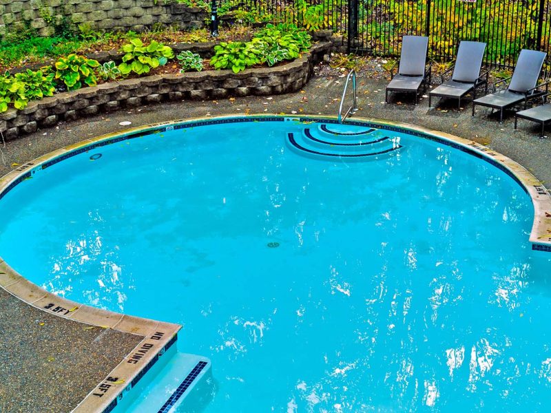 This image shows the resort-style outdoor swimming pool with grill area.